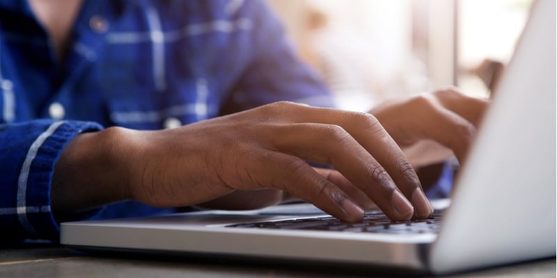 Bussinessperson typing on laptop